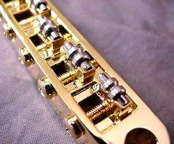 GOLD ROLLER BRIDGE AND STUDS FOR ELECTRIC GUITAR  