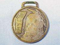 Dia. Brass Watch Fob of Indian with baby in papoose. Some of 