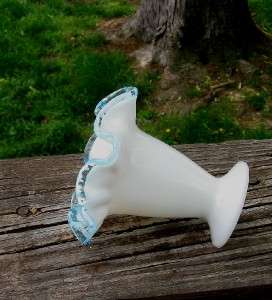 This is a nice little Fenton glass blue crest on white Vase  Damage 