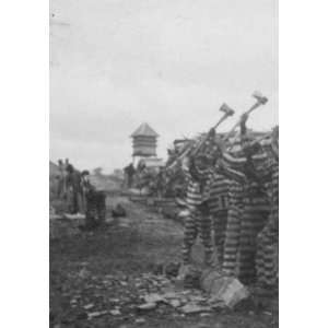  African American convicts working with axes, watchtower in 