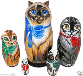 Beautiful set of five nesting dolls is carved of wood, hand painted 