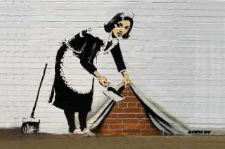 Banksy Maid Sweeping Wall   Graffiti street art  